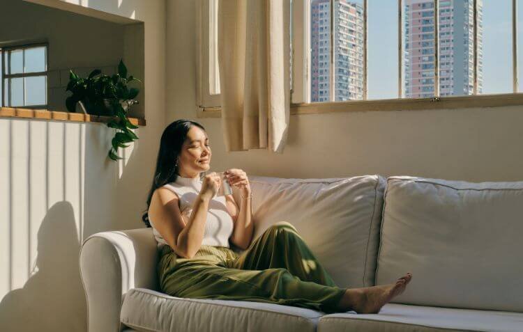 woman sitting on a couch in sunlight